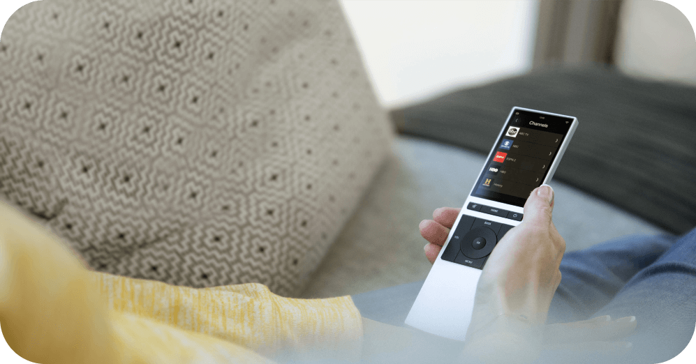 woman holds smart remote in her hand