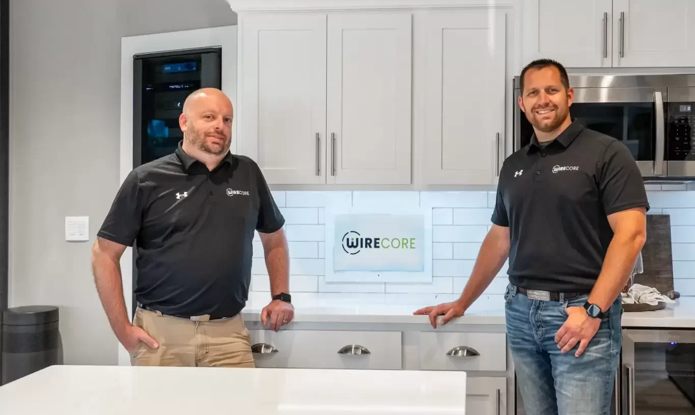two wirecore team members stand inside showroom kitchen