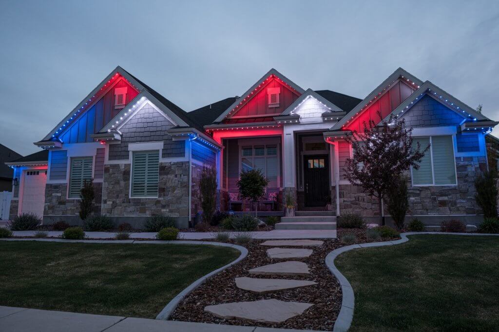 house with blue and red lights along the gutters