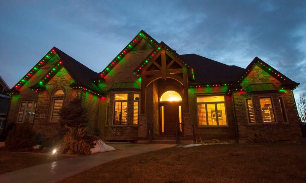 house with red and green lights along the gutters